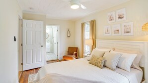A bedroom with a bed, a chair, a ceiling fan, and framed pictures on the wall. - Lake Wales Vacation Rental w/ Screened-in Porch! (Lake Wales)