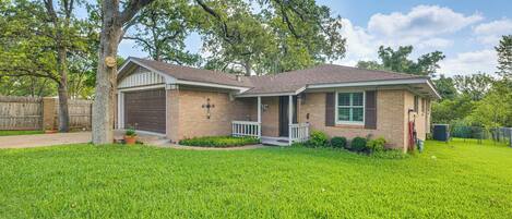A single-story house with a front garage, a covered porch, and a well-maintained lawn.
