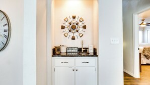 A kitchen with white cabinets, a black countertop, and a decorative clock. - < 1 Mi to OU Campus - Norman Vacation Rental (Norman)