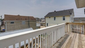 A residential area with houses, a wooden deck, and a white railing. - Sunny Seaside Heights Retreat: Walkable Location! (Seaside Heights)
