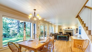 A spacious dining area with a wooden table and chairs, a chandelier, and a view of the outdoors. - Spacious Tahoe City Retreat < 2 Mi to Lake Tahoe! (Tahoe City)
