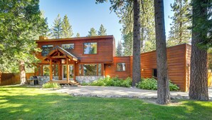 A modern log cabin with a stone foundation, large windows, and a well-maintained lawn. - Spacious Tahoe City Retreat < 2 Mi to Lake Tahoe! (Tahoe City)