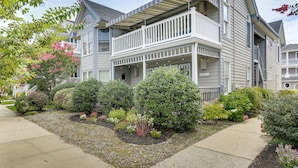 A two-story house with a covered porch and a landscaped garden. - Ocean City Home 1 Block to Beach & Boardwalk! (Ocean City)