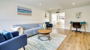 A spacious living area with a sofa, chairs, a coffee table, and a desk. - Charming Beach Haven West Home: 1 Mi to Beach! (Manahawkin)