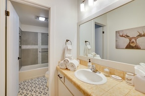 A bathroom with a bathtub, a sink, a mirror, and a shower. - Brian Head Rental w/ Community Hot Tub & Sauna! (Brian Head)