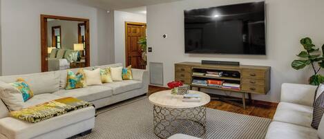 A modern living room with a sofa, coffee table, and TV.