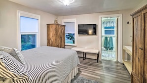 A bedroom with a bed, a wooden wardrobe, a bench, and a view of the outside. - California Cottage < 4 Mi to Redwood Hiking Trails (Ben Lomond)