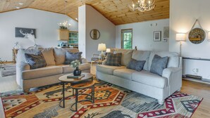 A cozy living room with two sofas, a coffee table, and a patterned rug. - Mtn-view Escape w/ Hot Tub, 9 Mi to Skiing! (Maggie Valley)