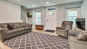 A living room with a grey sofa, a patterned rug, and two armchairs. - Large Historic Home in Pennsylvania Dutch Country! (Coatesville)
