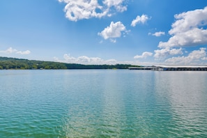 A calm lake with a clear sky and distant trees. - Serene Kimberling City Retreat w/ Boat Dock & Slip (Kimberling City)