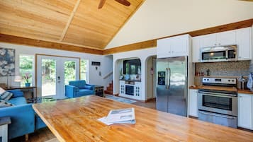 A spacious kitchen with wooden cabinets, a large island, and stainless steel appliances.