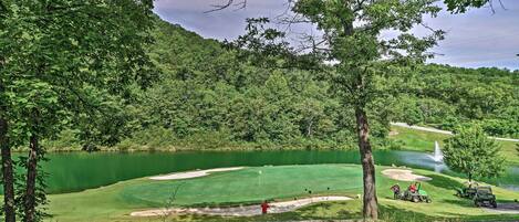 A golf course with a pond, sand bunkers, and a water hazard.