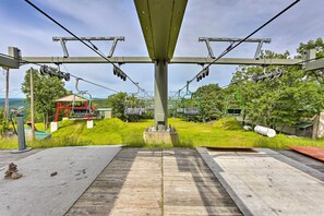 A cable car station with a wooden platform, a small structure with a red roof, and green surroundings. - Pools & Ski Access: Lackawaxen Cottage w/ Deck! (Lackawaxen)