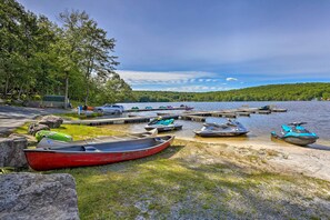 A lakeside dock with various boats and jet skis, surrounded by trees and a clear sky. - Pools & Ski Access: Lackawaxen Cottage w/ Deck! (Lackawaxen)