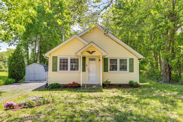 A small, single-story house with a gabled roof, a front porch, and a garage. - All-season Vernon Township Lake House Retreat! (Highland Lakes)