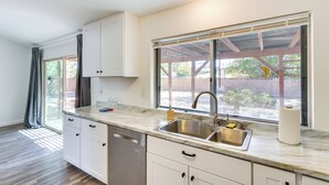 A kitchen with a sink, cabinets, and a window with blinds. - Quiet Ridgecrest Vacation Rental w/ Private Yard! (Ridgecrest)