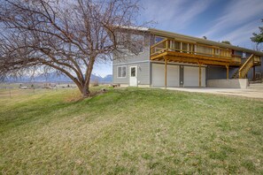 A two-story house with a wooden deck and a garage.