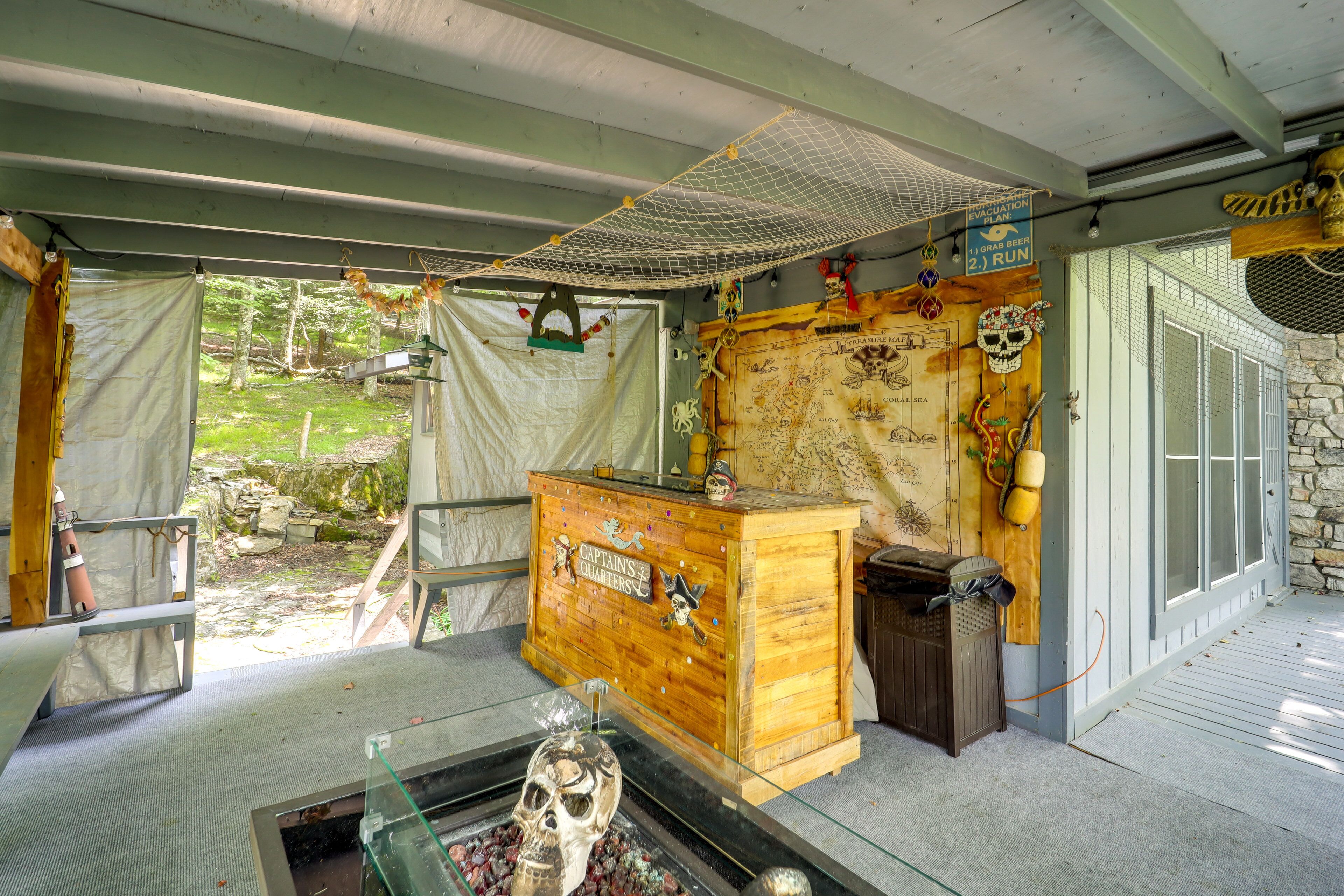 A room with a wooden chest labeled "Captain's Cabin," a glass display case with a skull, and a map on the wall.