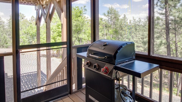 A balcony with a grill and a view of trees. - 2 Mi to Show Low Lake: Scenic Cabin w/ Balcony (Show Low)