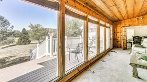 A covered porch with large windows, a wooden ceiling, and a view of a backyard. - Spacious Coarsegold Getaway ~ 34 Mi to Yosemite! (Coarsegold)