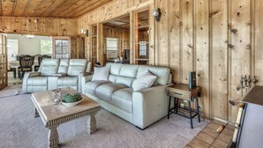A wooden-paneled room with a sofa, coffee table, and a television. - Spacious Coarsegold Getaway ~ 34 Mi to Yosemite! (Coarsegold)