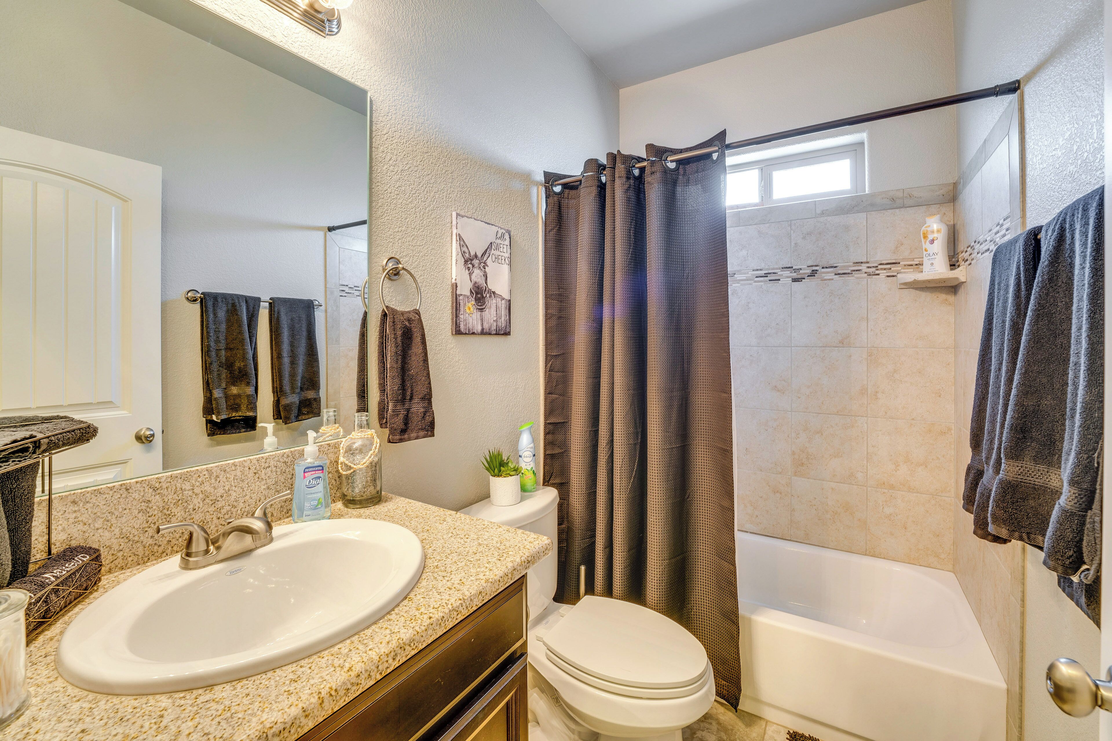 A bathroom with a sink, toilet, and bathtub.
