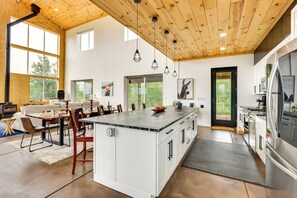 A spacious kitchen with a large island, wooden ceiling, and modern appliances. - Colorado Retreat w/ Gas Grill & Mountain Views! (Fairplay)