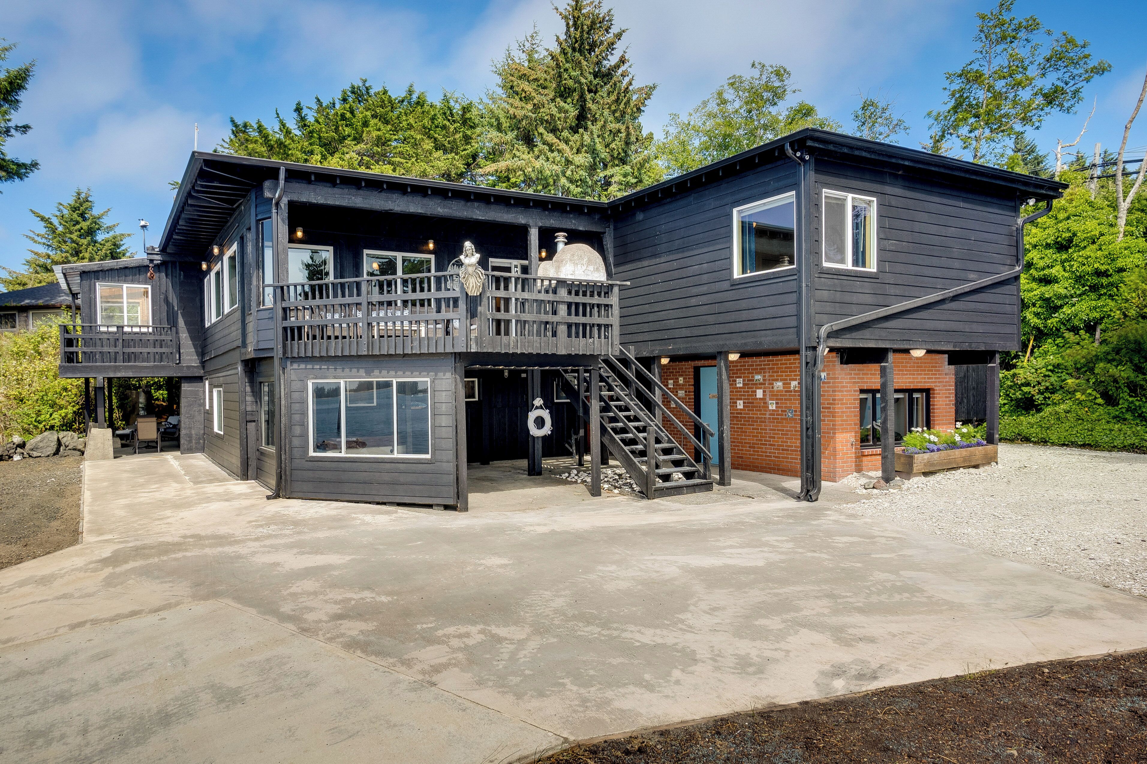 A two-story house with a balcony, a chimney, and a staircase leading to the upper level.