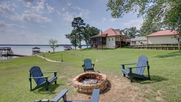 Una propiedad frente al lago con un brasero, asientos exteriores y vistas al lago.