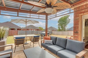A covered patio with a ceiling fan, outdoor furniture, and a view of the backyard. - Private Patio + Yard: Home By Tinker & Hospitals! (Oklahoma City)