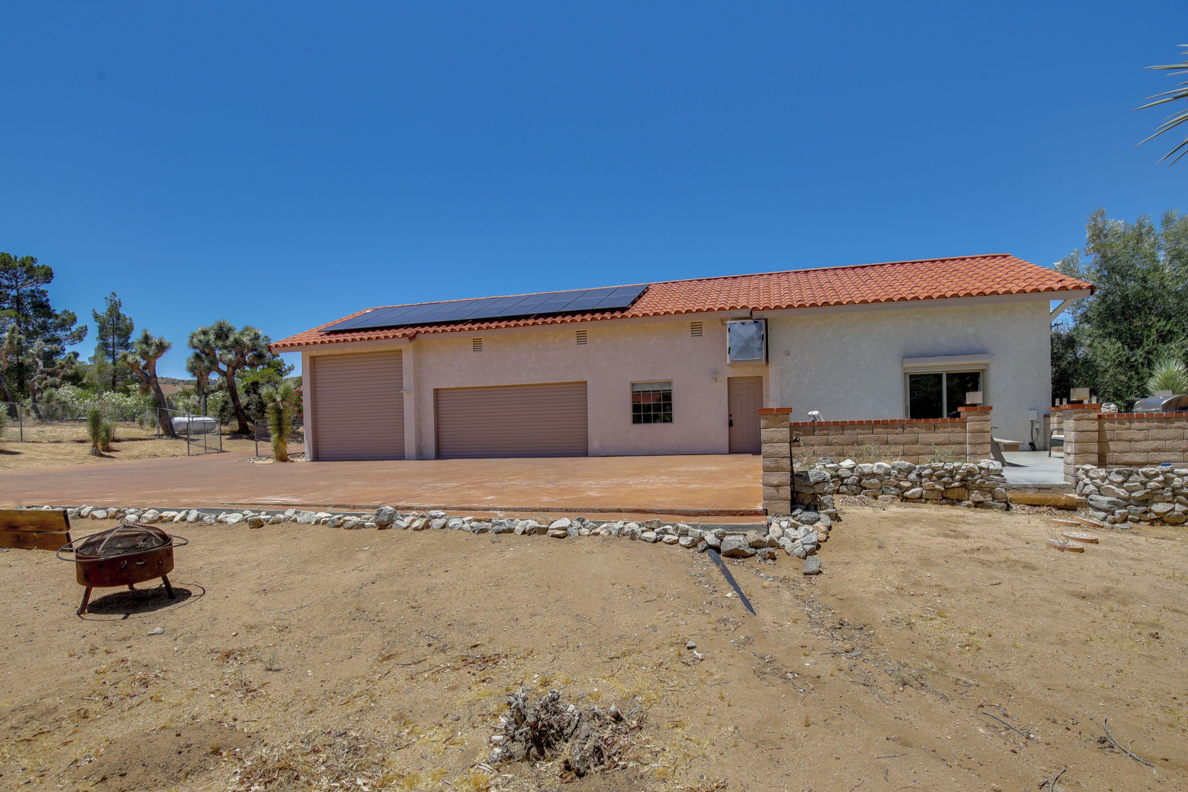 A single-story building with a red-tiled roof, a garage, and a small porch.