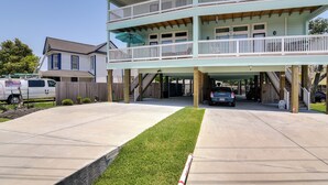 A two-story building with a covered entrance and a second-floor balcony. - La Porte Home w/ Balconies: Walk to Beach! (La Porte)