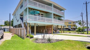 A two-story building with a balcony, a covered front porch, and a driveway. - La Porte Home w/ Balconies: Walk to Beach! (La Porte)