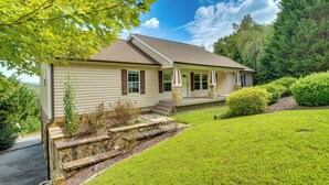 A single-story house with a front porch, stone steps, and a well-maintained lawn. - Hendersonville Retreat w/ Mtn Views & Deck! (Hendersonville)