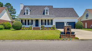 A two-story house with a front porch, a garage, and a brick mailbox. - Roomy Fayetteville Home Rental w/ Screened Porch! (Fayetteville)