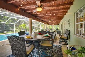 A covered patio with a pool, wicker furniture, and ceiling fans. - Florida Escape w/ Pool ~ 16 Mi to Fort Lauderdale! (Plantation)