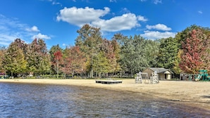 A lakeside park with a sandy beach, a playground, and a small building. - Pocono Lake Retreat w/ Fire Pit: Near Beach! (Pocono Lake)