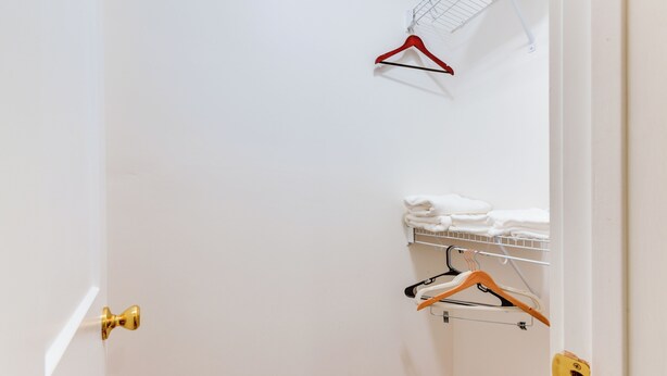 A room with a white door, a towel rack with white towels, and a red hanger. - 3 Mi to Dtwn Winston-salem: Studio on Miller Park! (Winston-Salem)
