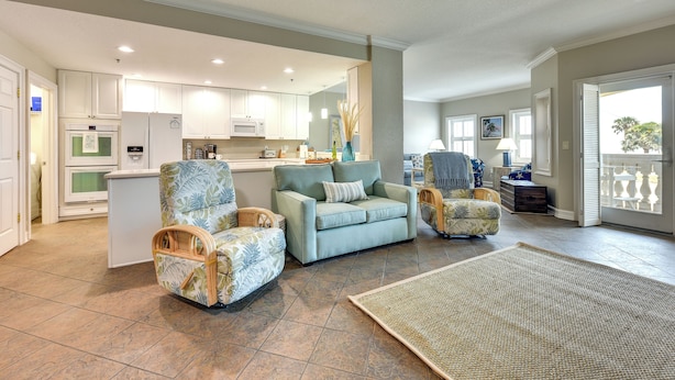 A spacious living area with a sofa, two armchairs, a coffee table, and a kitchen in the background. - Pet-friendly Fernandina Beach Condo: Walk to Beach (Fernandina Beach)