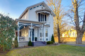 A white two-story house with a porch, a small front yard, and a tree. - Pearl Creek House w/ Barrel Sauna & Fire Pit! (Purling)