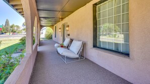 A covered outdoor seating area with a sofa and chairs, a potted plant, and a view of the street. - Pet-friendly Pueblo Vacation Rental w/ Patio! (Pueblo)