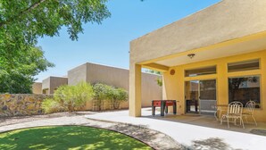 A building with a yellow exterior, a pool, and outdoor seating. - Las Cruces Vacation Rental Near Trails & Golf! (Las Cruces)