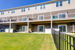 A multi-story residential building with balconies, sliding glass doors, and a well-maintained lawn. - Beaufort Getaway w/ Pool Access, 2 Mi to Downtown! (Beaufort)