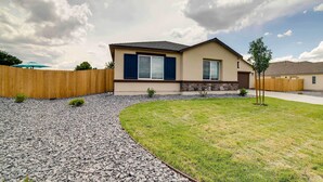 A modern two-story house with a beige exterior, a dark blue window trim, and a sloped roof. - Newly Built Sparks Home w/ Hot Tub: 12 Mi to Reno! (Sparks)