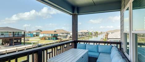 A balcony with a view of a waterway and buildings.