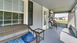 A covered porch with wicker furniture and a glass table. - Pet-friendly Home w/ Yard, Near Downtown Royal Oak (Royal Oak)