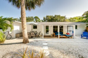A covered patio with outdoor furniture, a bicycle, and a palm tree. - Osprey Vacation Rental w/ Kayaks: 4 Mi to Beach! (Osprey)