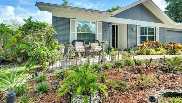 A modern house with a covered patio, outdoor seating, and a well-maintained garden. - Cozy Brandon Vacation Rental w/ Shared Pool! (Brandon)