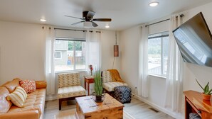 A modern living room with a sofa, chairs, a coffee table, and a TV. - Dolores Townhome w/ Mountain Views: Near River! (Dolores)