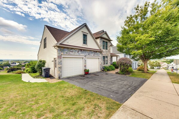 A two-story house with a garage, a driveway, and a well-maintained lawn. - Mountville Rental w/ Private Patio & Gas Grill! (Mountville)